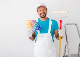 a painter holding a color palette and paint brush in his other hand