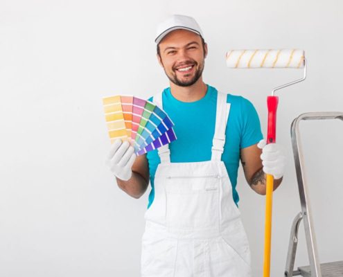 a painter holding a color palette and paint brush in his other hand