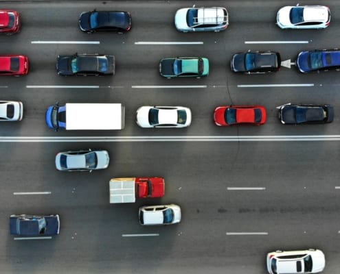 aerial view of a highway with one side jammed and one side moving freely
