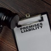 Premises liability document on clipboard with judge gavel on wooden desk