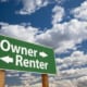 a sign with owner renter written on it pointing at the opposite directions