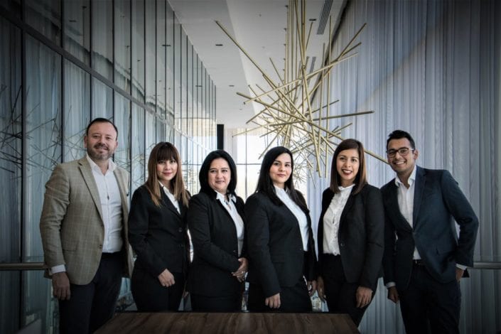Small Business Health Insurance Group of business professionals standing together in an office