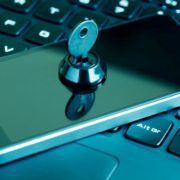 smartphone-cyber-security-thumbnail a phone on a laptop with a lock and key on it