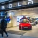 tesla storefront with a tesla roadster on display