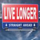 a highway sign with live longer written on it