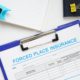 Forced place insurance form on clipboard with office supplies on desk