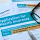 an application for health insurance on the table