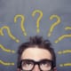 a persons head with questions marks around it
