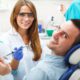 a man in a dental clinic with the dentist sitting in front of him