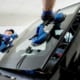 a car wind shield getting replaced by two mechanics