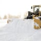 a snow plow plowing snow